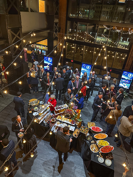 A crowd enjoying a networking reception during Evening with the Stars