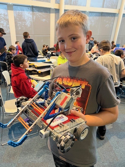 student with robotic creation