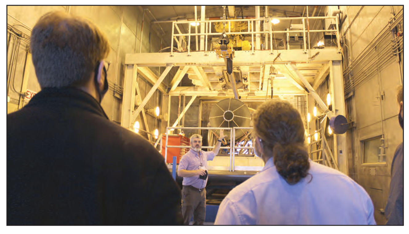 Bernie Williamson standing in front of the F404 engine, 